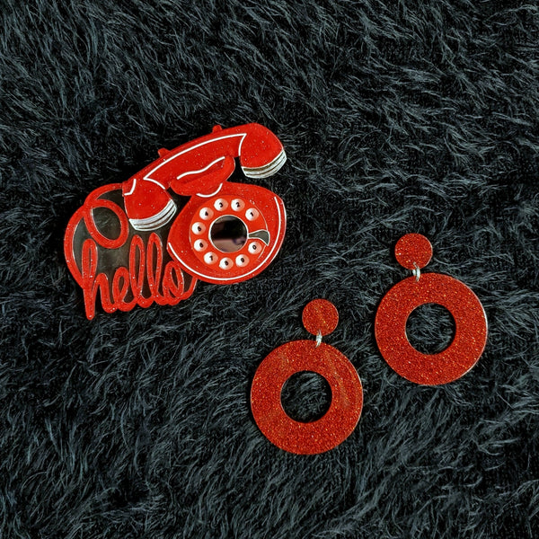 "Smooth Operator" glittery red vintage rotary dial phone with "hello" message cord 3" x 2" layered laser cut resin brooch, shown with matching red glitter hoop earrings