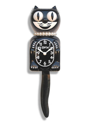black & white Kit-Cat wall mount clock features white pearl necklace, black eyelashes, a mischievous grin, and big round eyes that swivel side-to-side in time with its pendulum tail 