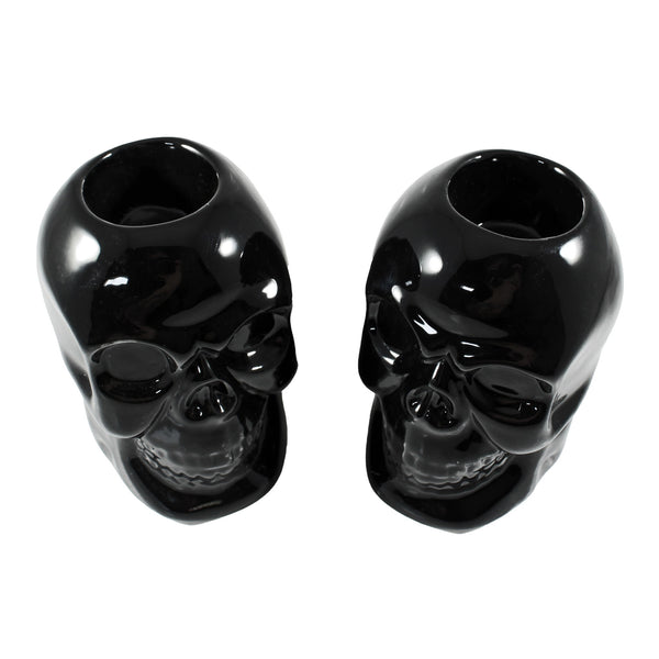 pair of porcelain skull shaped candleholders in black