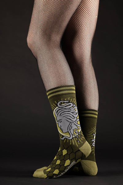 pair green and grey Medusa design soft stretch cotton blend crew socks, shown on model