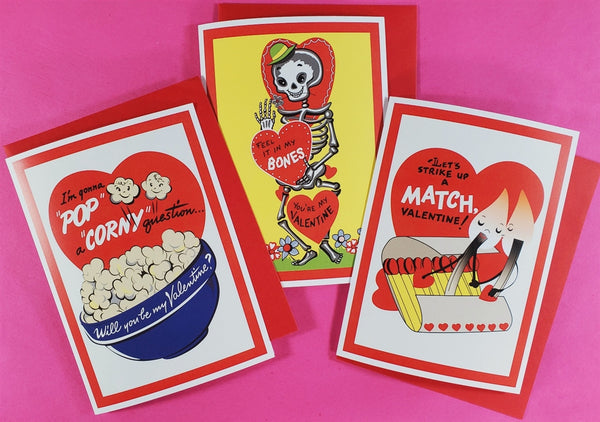 three vintage style valentine cards against bright pink background