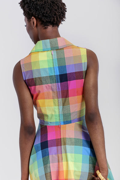 rainbow check plaid dress features a fitted sleeveless bodice with pink button closure and wide pointed collar, and full just-below-the-knee length skirt, shown close up bodice back view on model