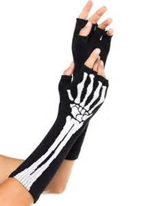 mid-forearm length black acrylic knit fingerless gloves with knit-in white skeleton design, shown on model