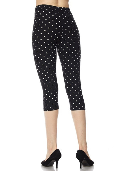 high-waist capri length leggings in a black & white polka dot print, shown back view  on model