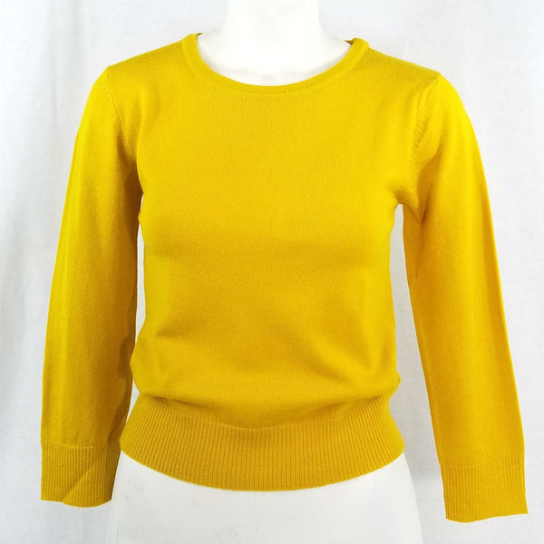 fitted pullover sweater in a slightly cropped length with crew neck and 3/4 sleeves in honey mustard yellow, shown on mannequin