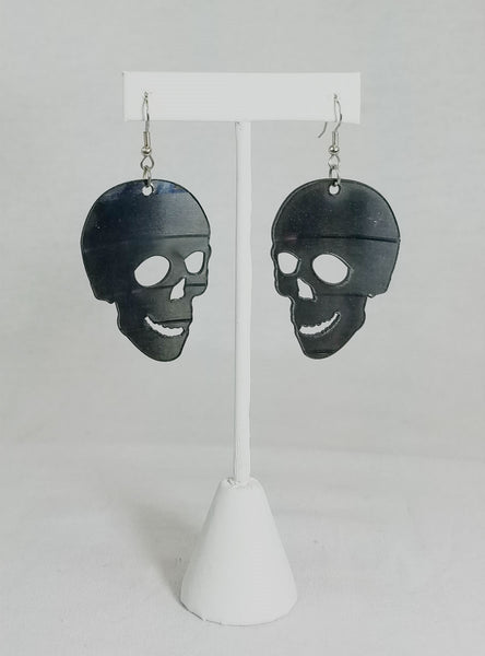opposing pair 2" black skull earrings made from laser cut recycled vinyl records