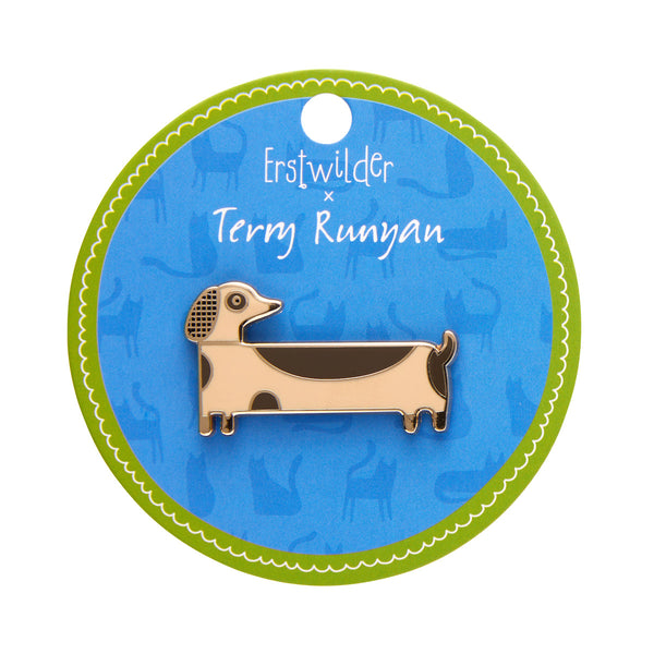Terry Runyan collaboration collection "Long Dog" enameled gold metal dachshund clutch back pin, shown on round illustrated backer card packaging