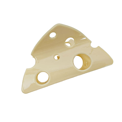 Pale yellow claw style hair clip in the shape of a triangular wedge of cheese with Swiss style holes