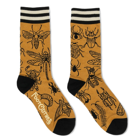 mustard unisex crew socks with black and off-white striped cuffs & black toes/heels with an all over pattern of bug illustrations with black outlines including scorpions, dragonflies, centipedes, moths, and spiders. Shown flat