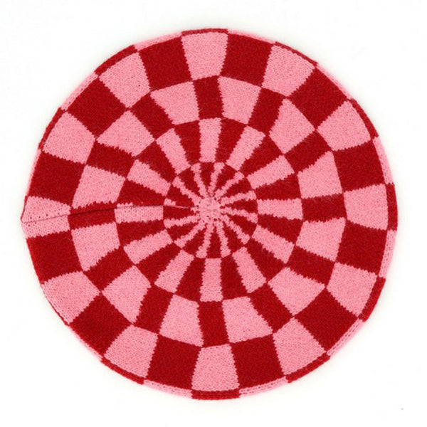 a red and pink checker patterned knit beret shown flat against a plain background