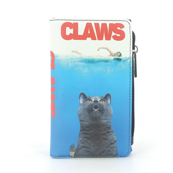 A zip-closure faux leather wallet featuring a graphic print of a gray cat in the water with the word 'CLAWS' in red at the top in the style of the JAWS movie poster, shown on a plain white background.