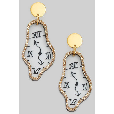 drop earrings with a pair of transparent acrylic charms in the shape of melting clock faces with gold glitter trim attached to round gold metal charm