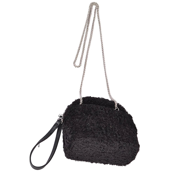 Black textured bouclé faux fur wristlet bag with a curved top and a black faux leather wrist strap, shown from front with chain shoulder strap attached