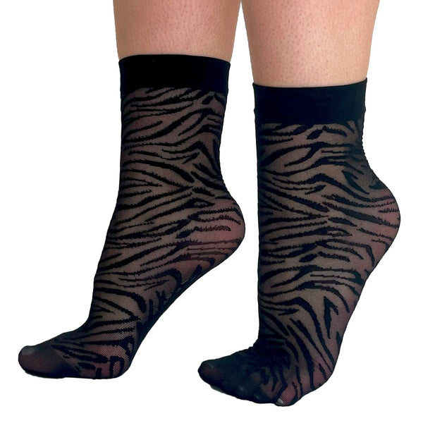 Black mesh ankle socks with a solid black cuff and a tiger print pattern. Shown on a model shown from the side
