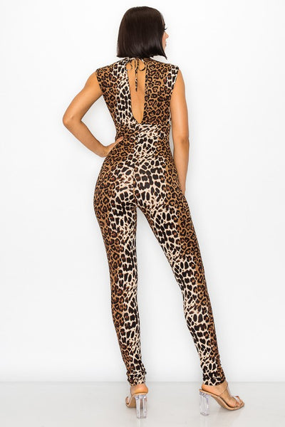 Model wearing a natural brown leopard print patterned knit catsuit with mock neck, v-shaped revealing side panels, and a keyhole style open back with tie detail. Shown from the back