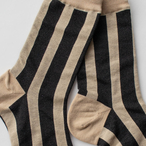 cotton knit crew socks in beige with a sleek black lurex vertical stripe pattern. Shown in close up