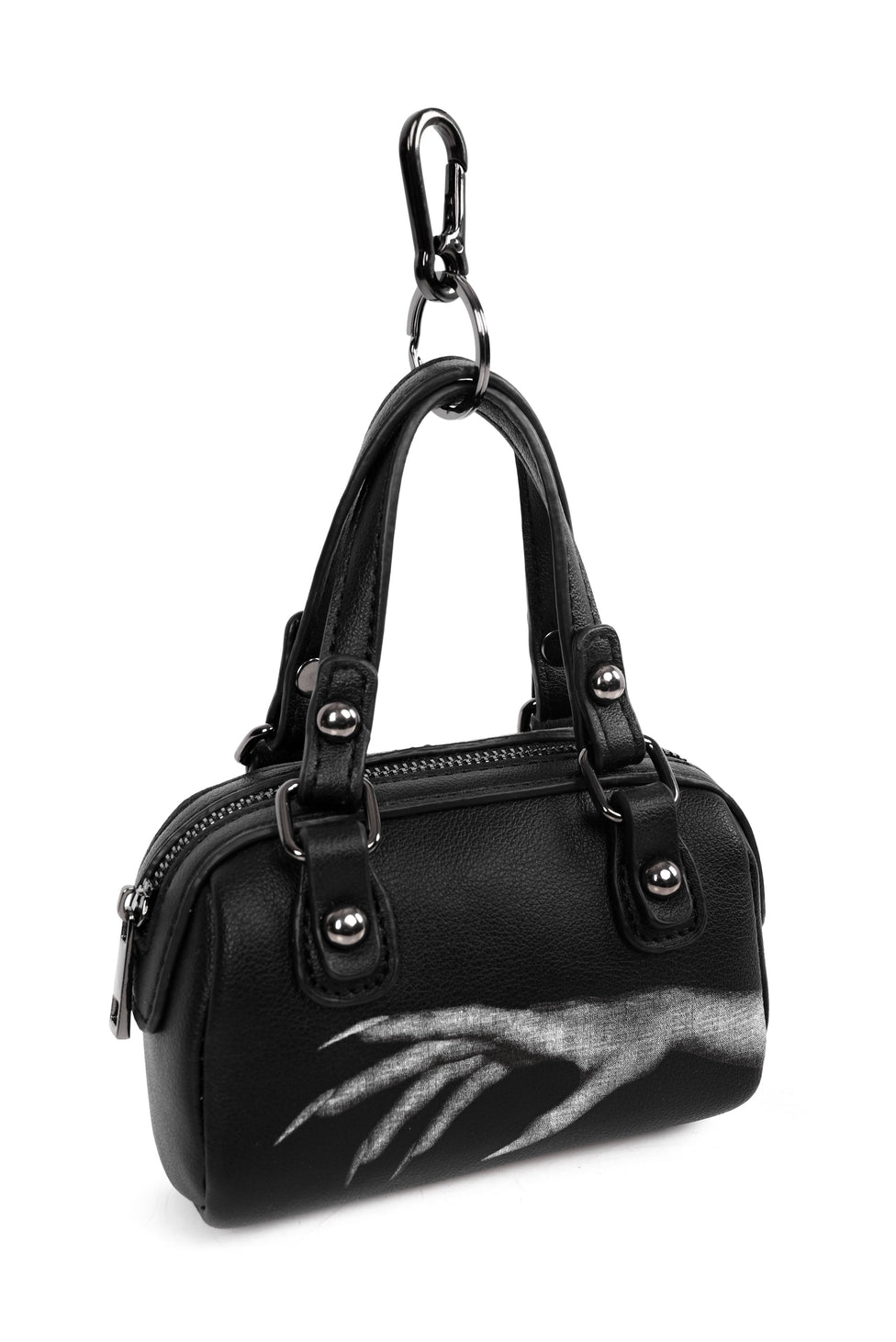 Black faux leather mini purse shaped bag charm with white printed design of vampiric hand with long nails. Bag has gunmetal hardware, zip closure, and split ring keychain with clasp. Shown from front