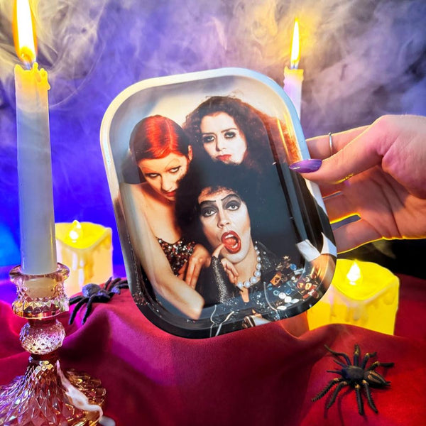 rectangular tin tray with rounded edges and shiny full color image of Columbia, Dr. Frank N. Furter, and Magenta from the Rocky Horror Picture Show. Shown held for scale