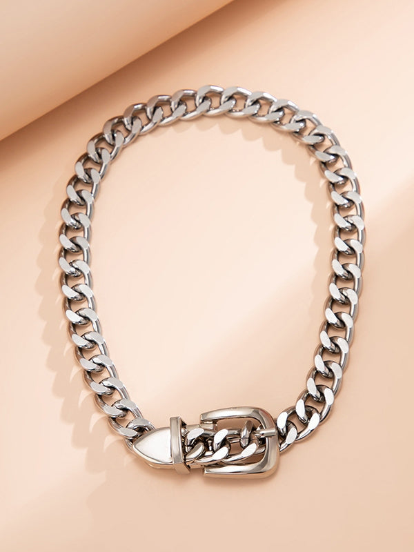 Silver metal curb style chain choker with belt style buckle and tail closure. Shown flat and closed