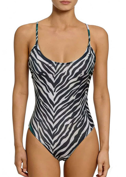 model wearing a black and white zebra print one-piece swimsuit with a scoop neckline, spaghetti straps that cross and tie at the lower back, and high-cut legs. Shown from front