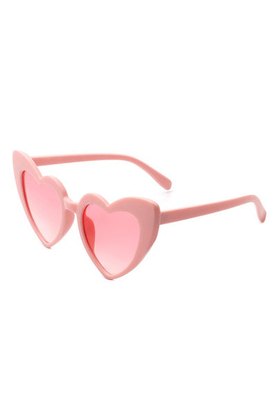 angular cat eye "Lolita" heart-shaped sunglasses in shiny baby pink with gradient pink lens, shown 3/4 view