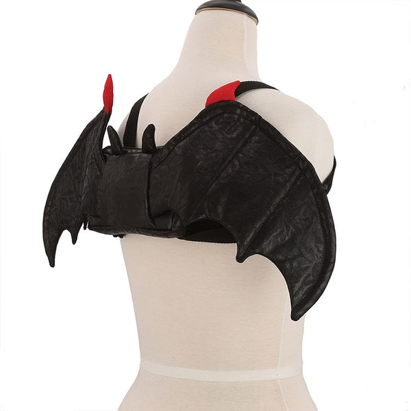 Novelty mini backpack in soft velvety black fabric with attached 24” wide batwing appliqué in matching fabric with red tips. Body of backpack is in matching fabric with pointy bat ears. Shown on dress form from side