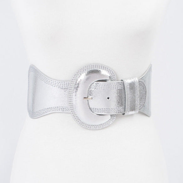 Shiny metallic silver elastic waist belt with self angled buckle. Shown from front