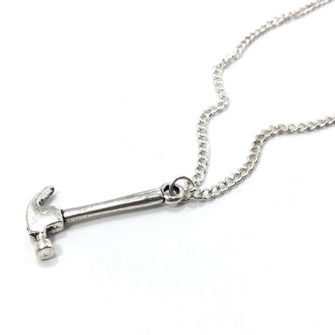 1" shiny silver metal hammer suspended on a 16" silver metal link chain, showing close up of pendant