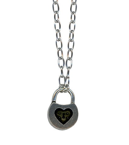 Silver metal toggle chain necklace with pewter padlock charm with inner black heart detail. Shown in close up of pendant