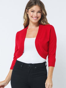 Open 3/4 sleeve bolero length cardigan with rounded bottom hem and ribbed border in bright red worn by a model 