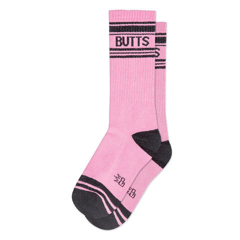Pink crew socks with black striped cuffs and toes with “BUTTS” written in black. Shown flat