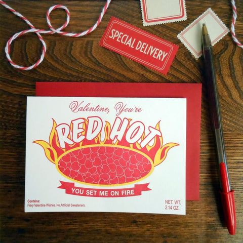 Rectangular letterpressed valentine card meant to resemble Red Hots candy packaging. Message of “Valentine, you’re RED HOT” “You set me on fire” “Contains: Fiery valentine wishes. No artificial sweeteners”