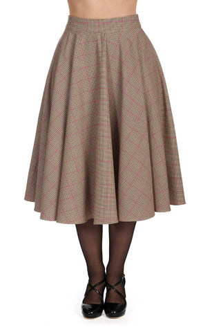 Model wearing a heavyweight 50s style swing skirt in a micro houndstooth windowpane plaid print in brown, black, cream, and pink. Shown from the front