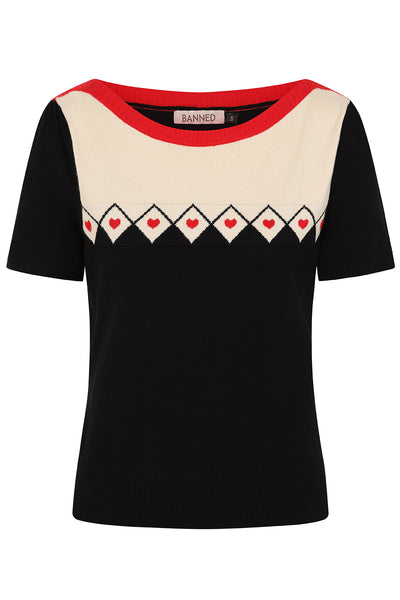 Short sleeve knit sweater with red slash neck and creamy white chest panel color blocked with black meeting at a row of black outlined white diamond shapes with tiny red hearts in the middle. Shown from front  