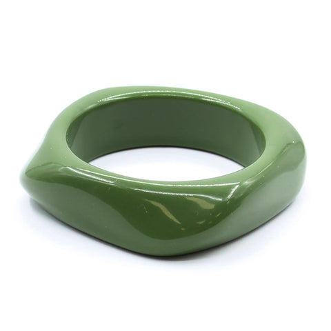 A shiny olive green resin bangle with a rounded irregular square shape