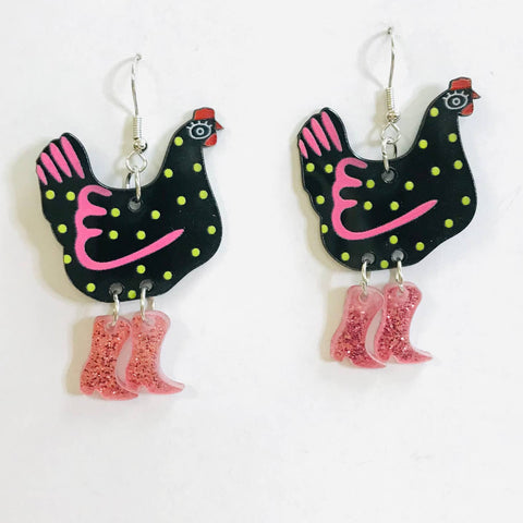Black chicken with yellow spots and pink highlights wearing pink glittery cowboy boots acrylic dangle earrings