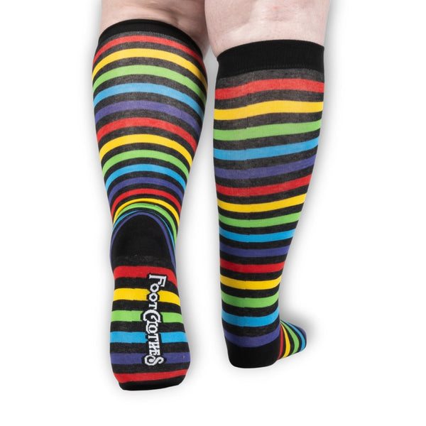 unisex wide calf fit black and rainbow stripe knee socks. Shown worn from the back