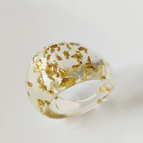 Rounded translucent acrylic ring with large flecks of gold glitter