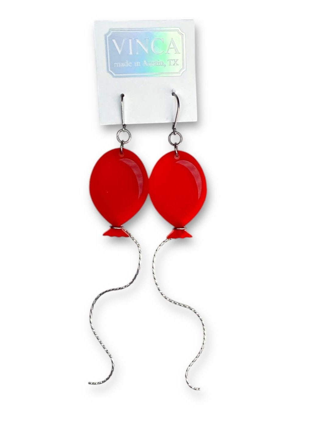 red frosted finish laser cut acrylic balloon dangle earrings with wavy sterling silver "string" wrapped around the bottom of each. Shown on backing card