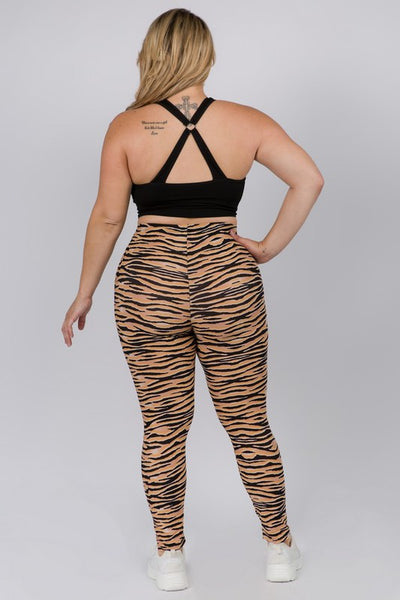 plus size model wearing high-waisted, full-length brushed fiber knit leggings with a black and orange tiger stripe pattern. Shown from back