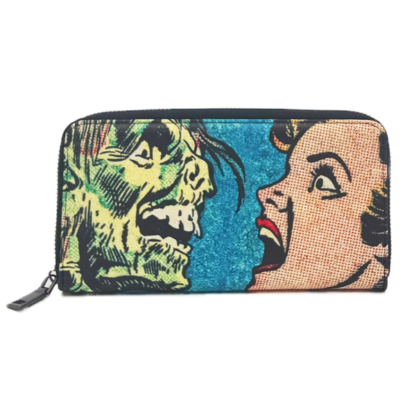 faux leather wristlet wallet with a printed Ben-Day woman's face and green monster design on a blue background shown