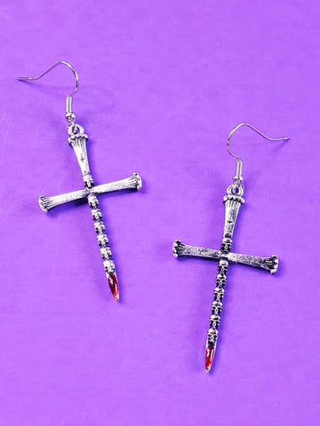 pair of silver metal dagger earrings with a blade made of tiny skulls & a bloody red jewel at each tip