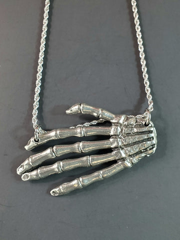 Large American pewter charm of a skeleton hand attached to a stainless steel rope chain 