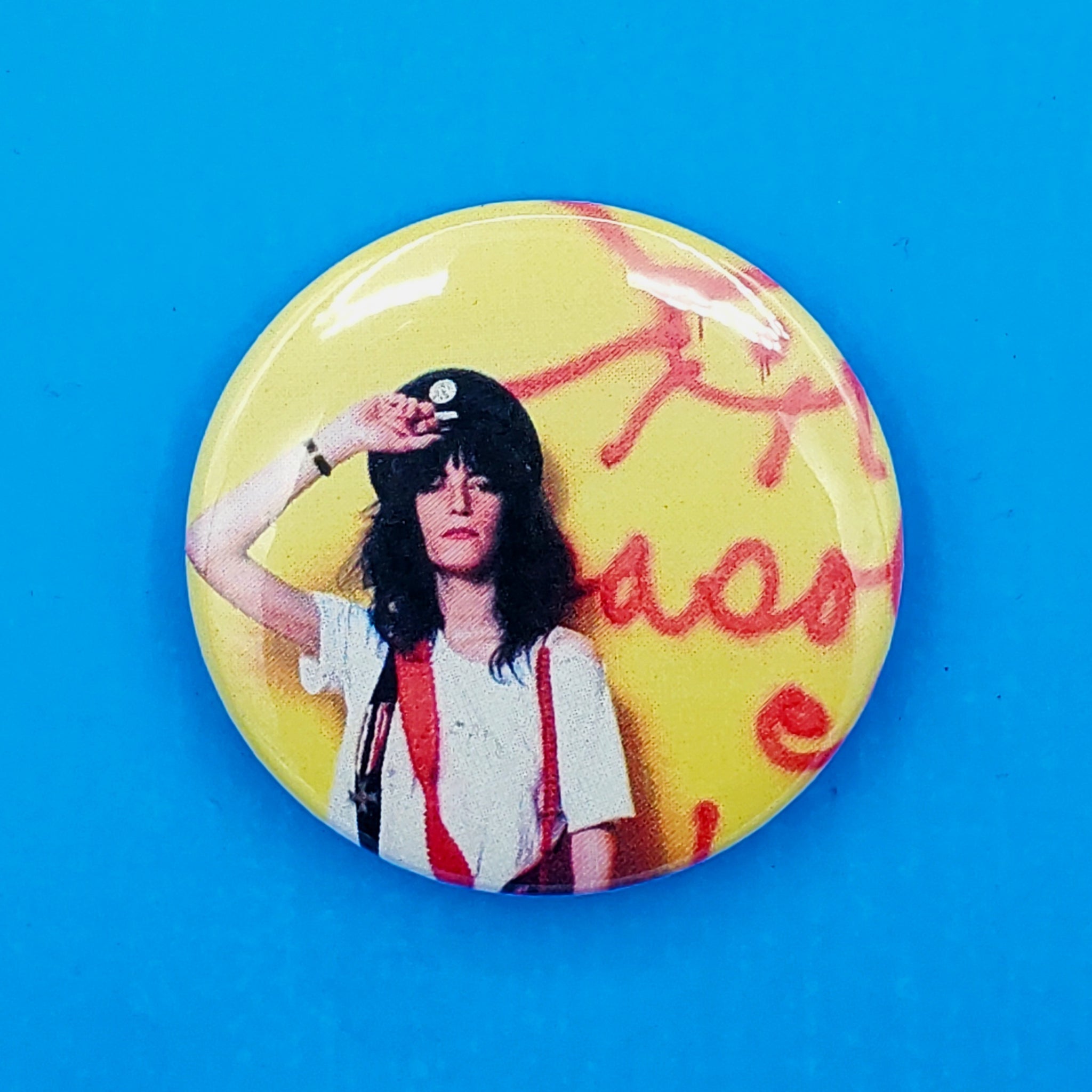 2.25" pinback button with a color portrait of the queen of original New York City punk herself, Patti Smith