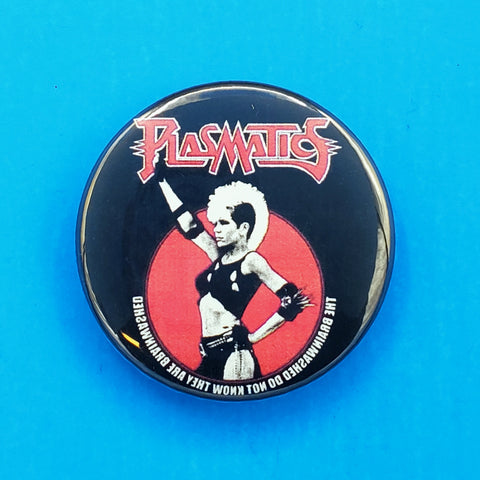 2.25" pinback button with a red, white, and black portrait of the frontwoman of the Plasmatics, Wendy O. Williams above the written-backwards text: the brainwashed do not know they are brainwashed
