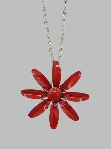 vintage-inspired metal daisy pendant in deep red on a 28” long shiny silver metal link chain