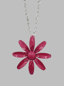 vintage-inspired metal daisy pendant in a deep shade of pink on a 28” long shiny silver metal link chain