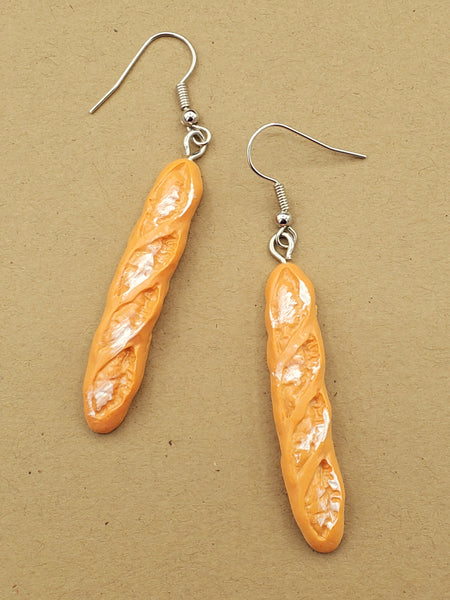 Dangle earrings with acrylic charms of loaves of baguette bread