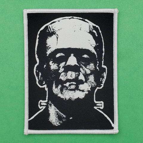 black woven rectangular patch with white embroidered border of Frankenstein's monster as portrayed by Boris Karloff in black and white