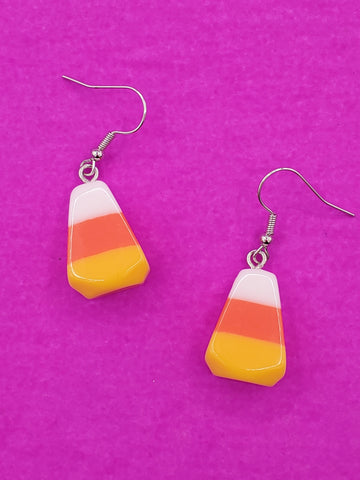 dangle earrings with acrylic charms in the chape of white, orange, and yellow candy corn